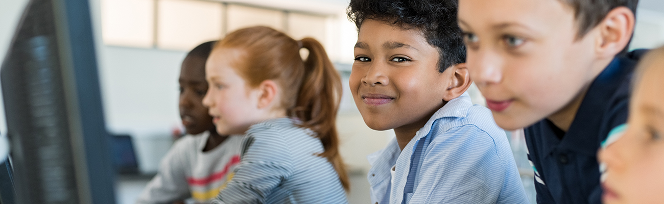 child and adult working at computer
